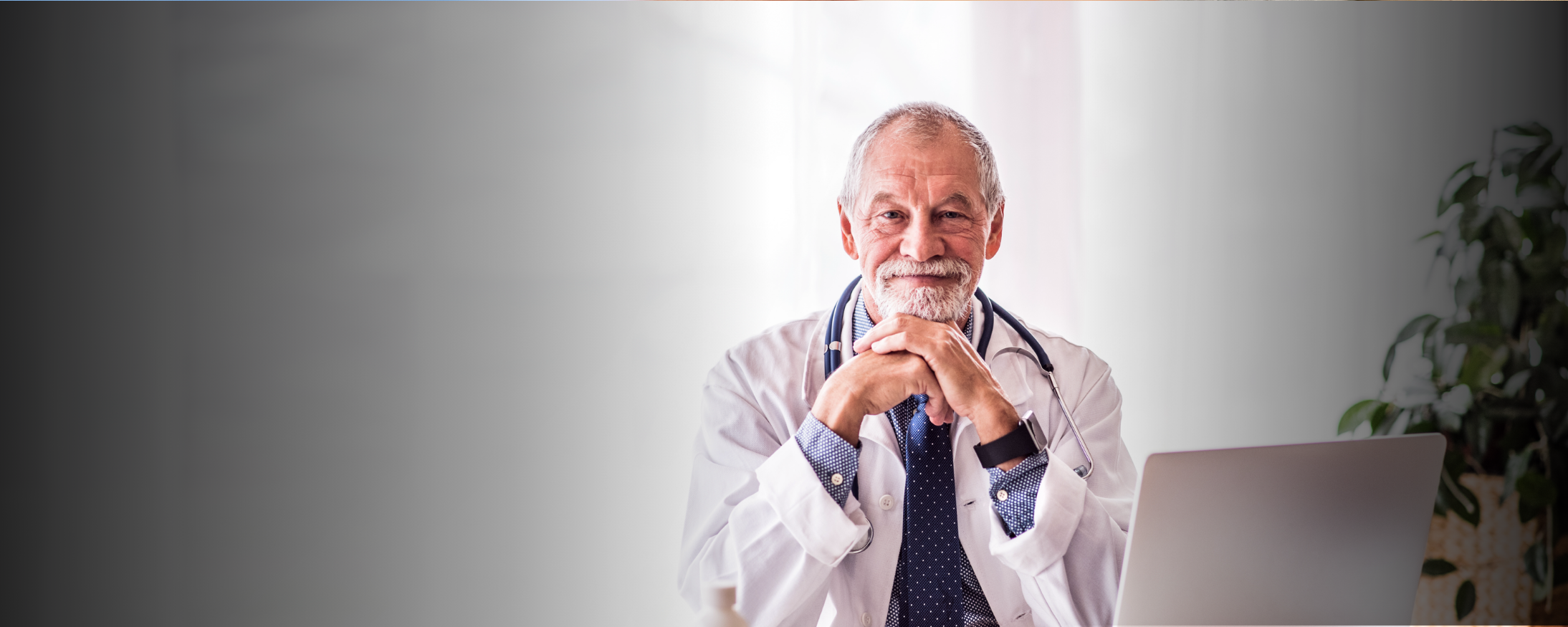Older doctor sitting and smiling